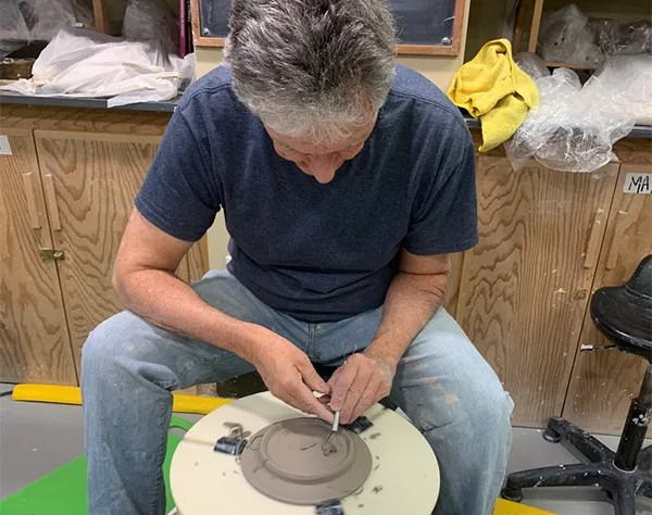 a photo of Will Kealey on the Pottery Wheel