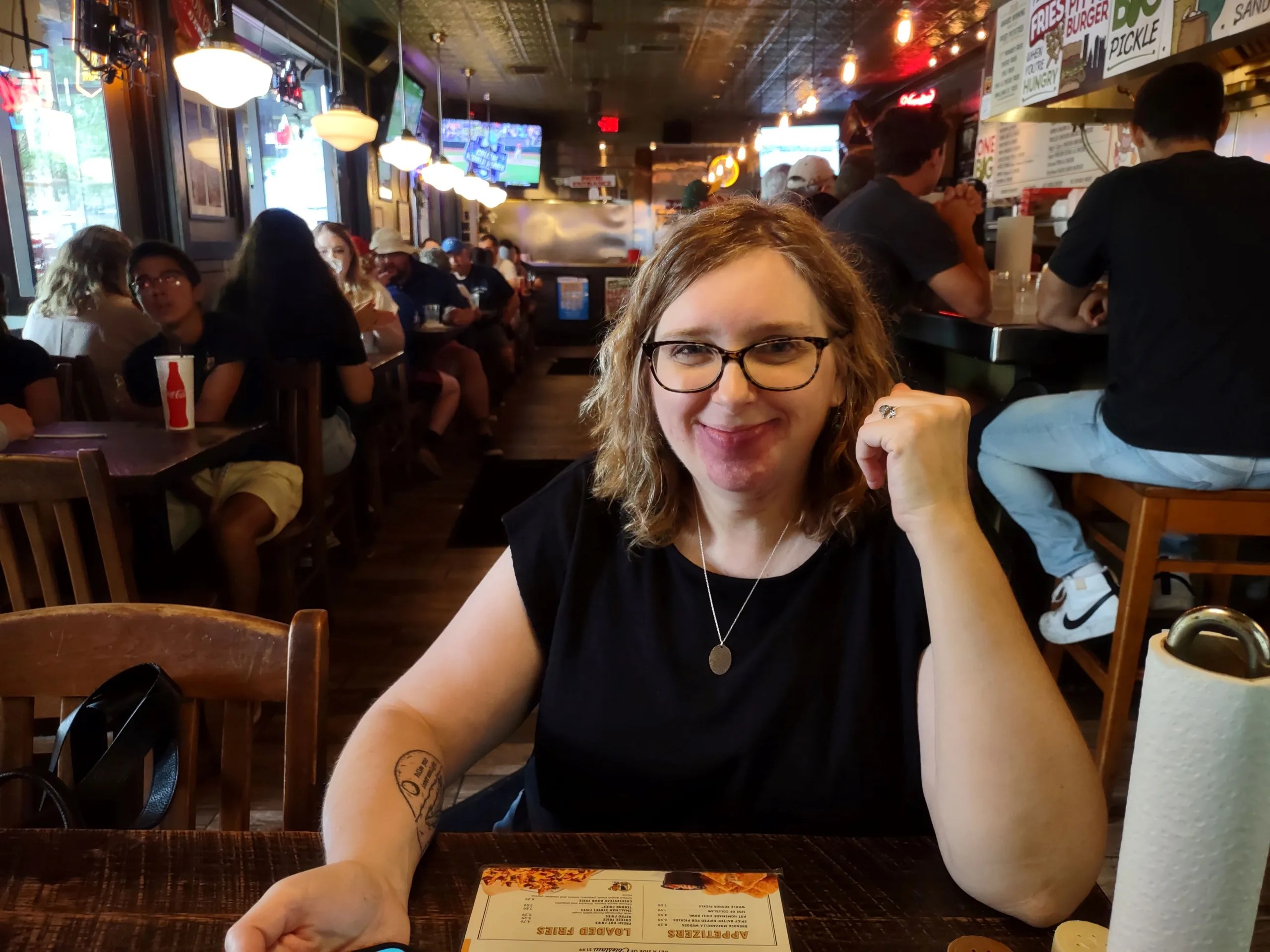 a woman in a restaurant looking at the camera
