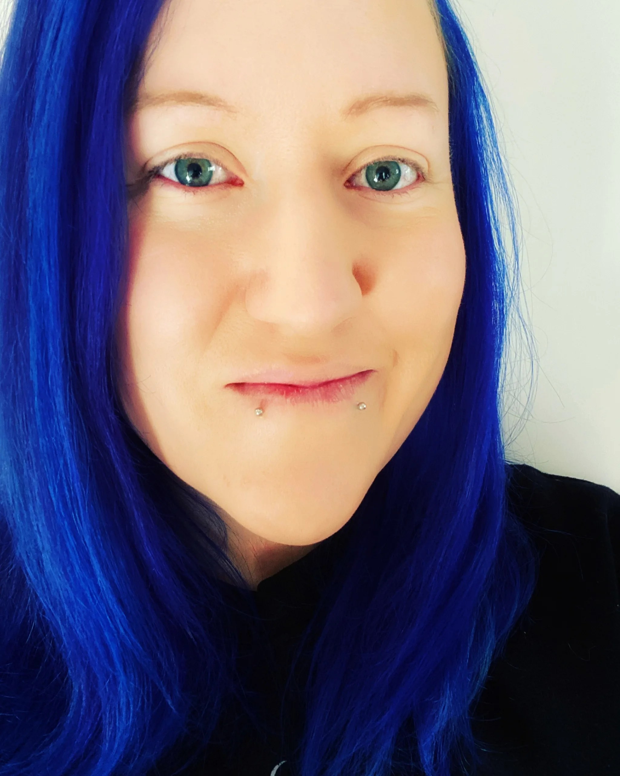 the face of a woman with blue hair