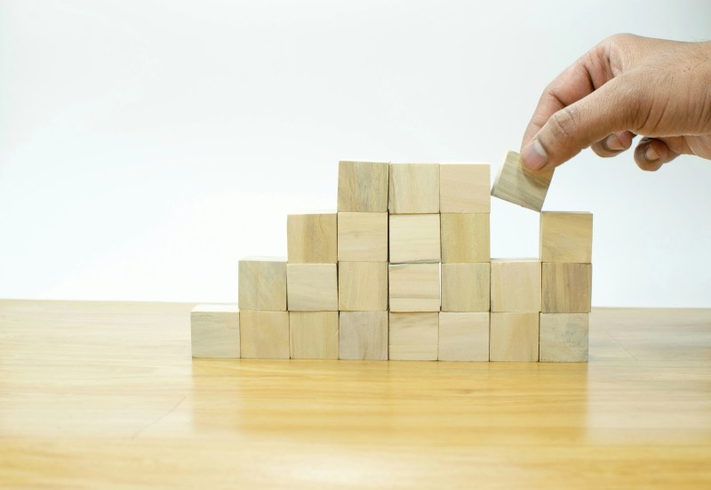 Hand Rearranging Wooden Building Blocks