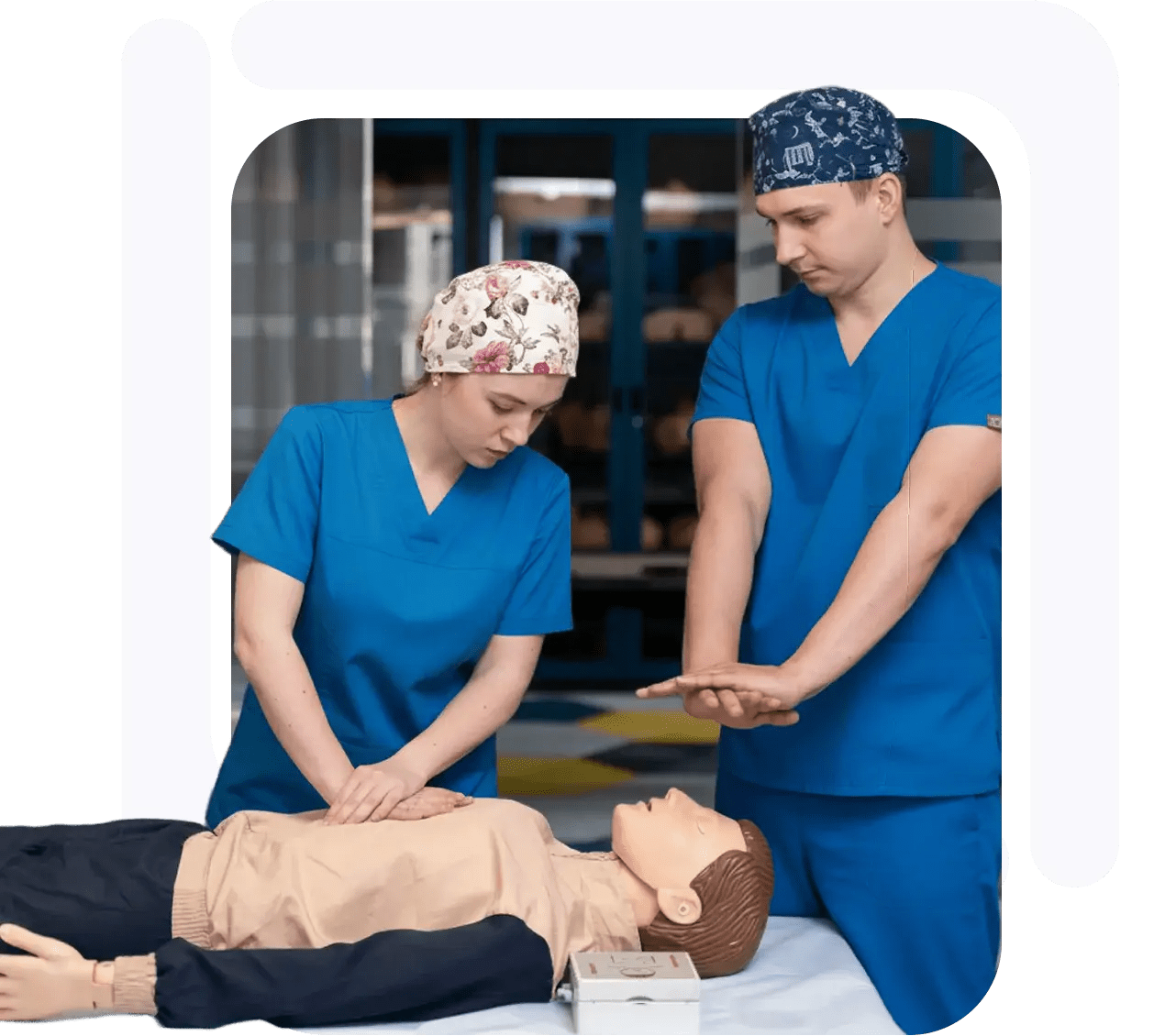 Two medical professionals performing CPR on a training mannequin during a training session.