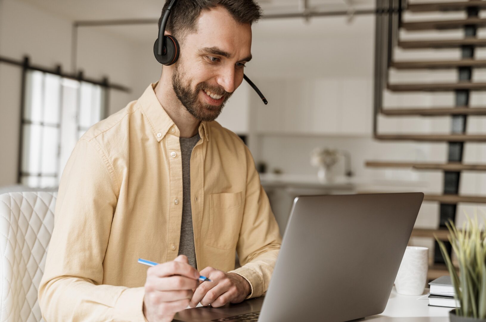 man-with-headset-having-video-call-laptop