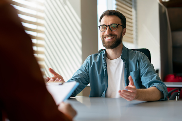 man-sitting-in-an-office-during-a-job-interview-carefully-thinking-on-what-to-say-dring-the-meeting