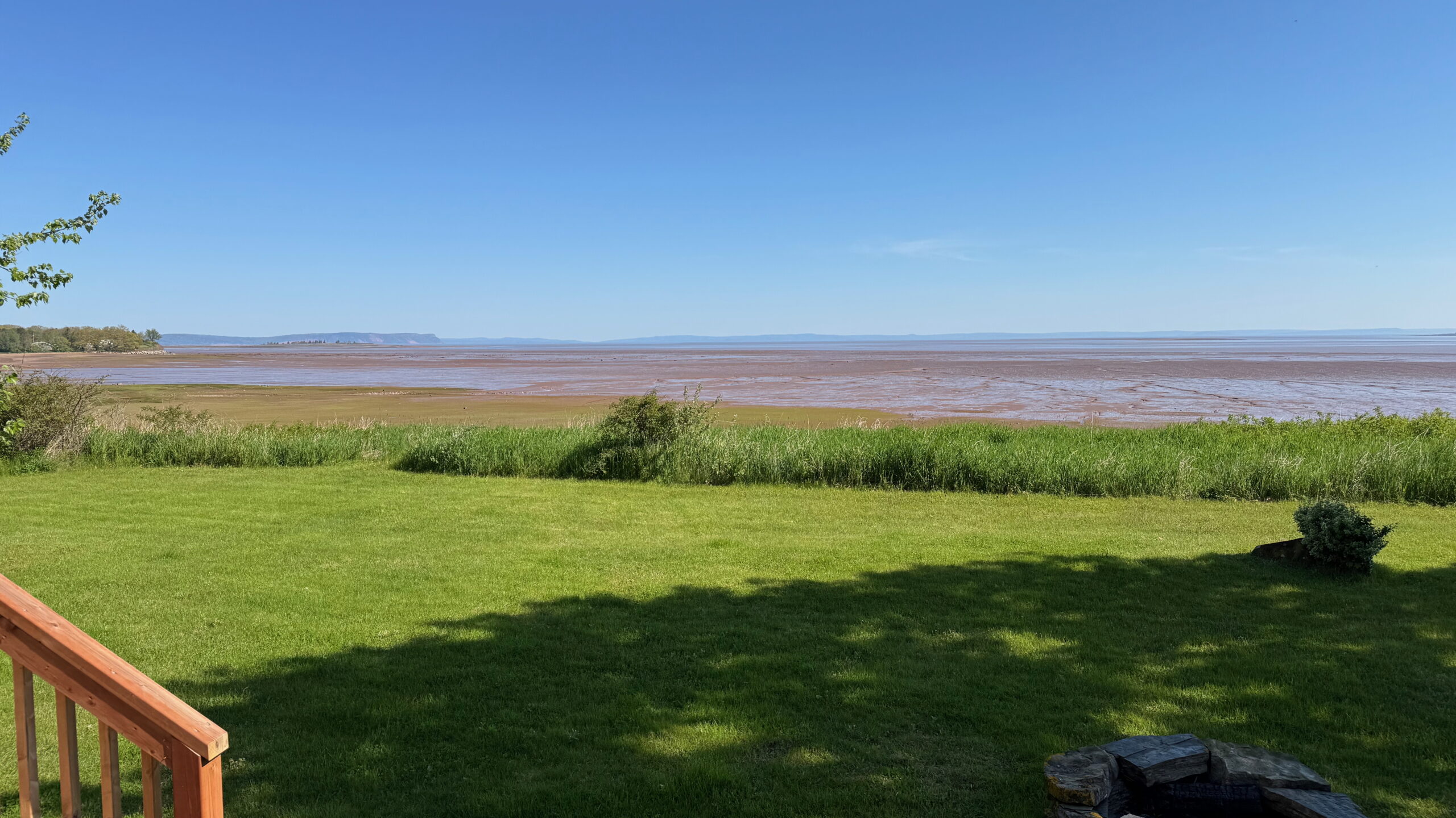 The Minas Basin at low tide. You can see the ocean floor of red-brown mud running into the horizon. You cannot see the where the ocean water begins.