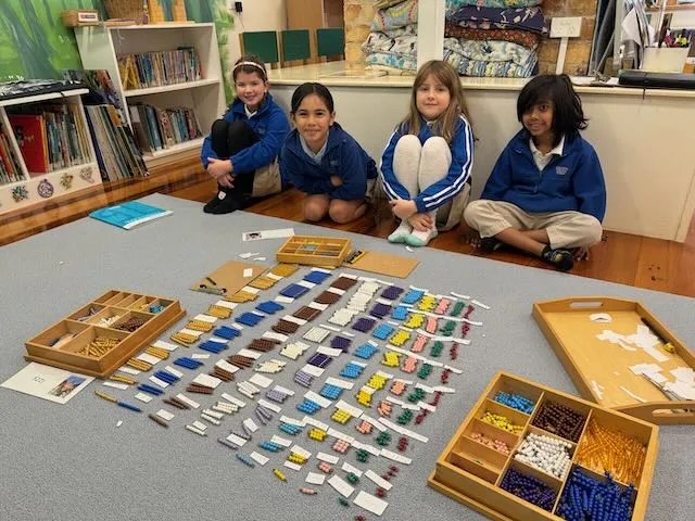 Students at golden grove montessori primary work on their knowledge of timestables together.