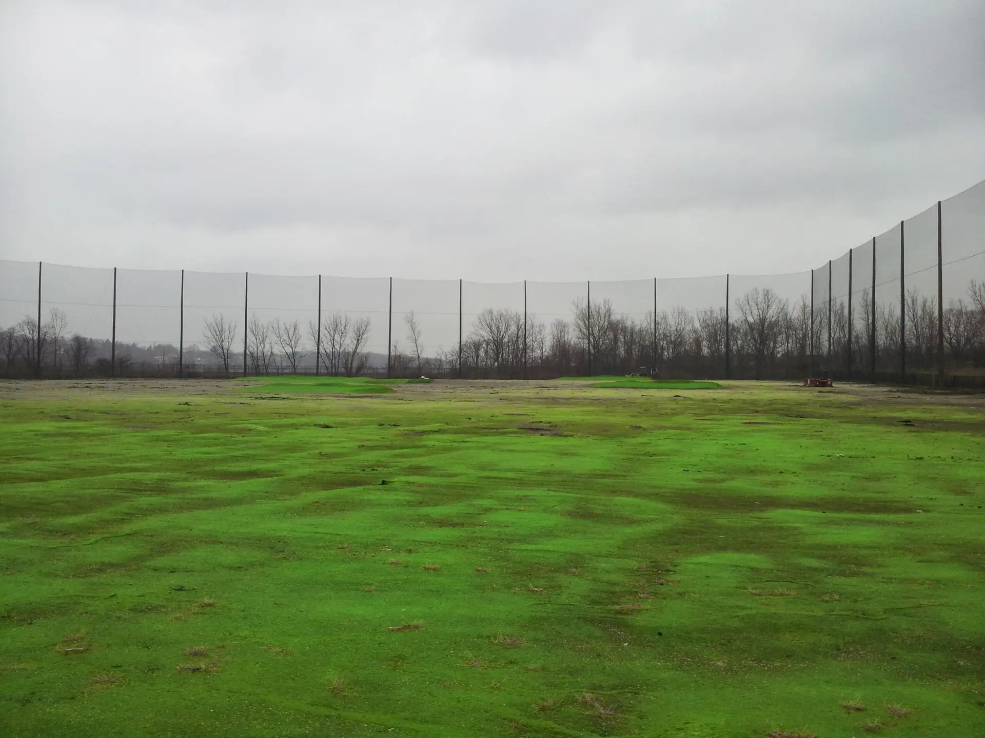 Completed driving range barrier net installation