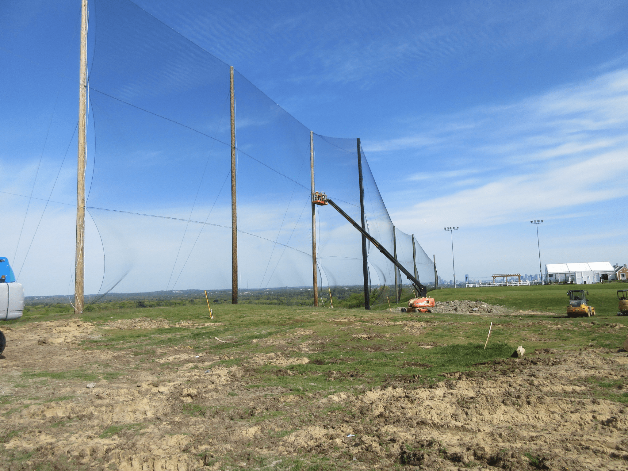 Installing golf netting panels for driving range