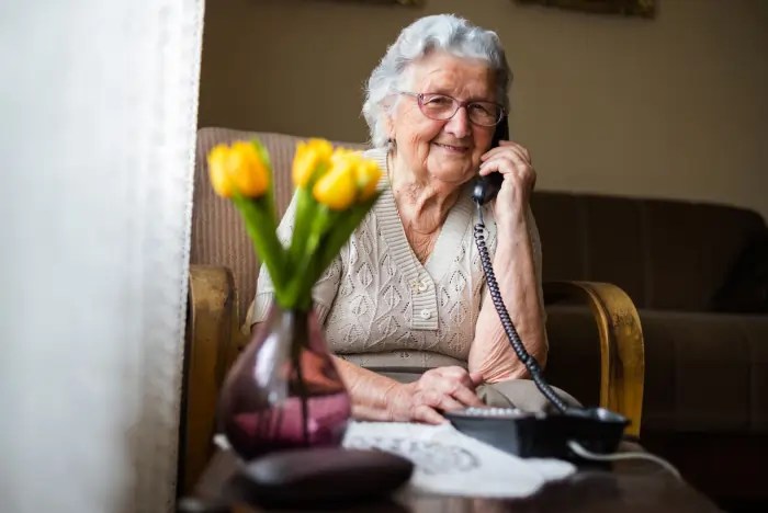 An elderly Good Life Sorted customer speaking on the telephone