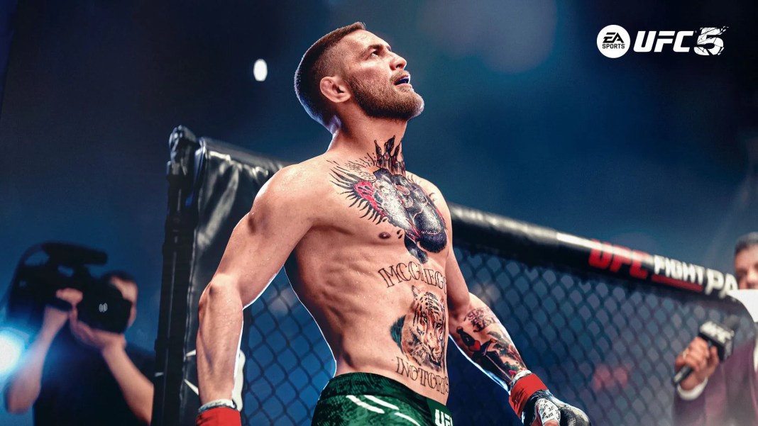 Conor McGregor with tattoos on his chest and arms standing in an octagon cage under bright lights, wearing green shorts and red gloves, with a focused expression. EA Sports UFC 5 logo in the top-right corner.