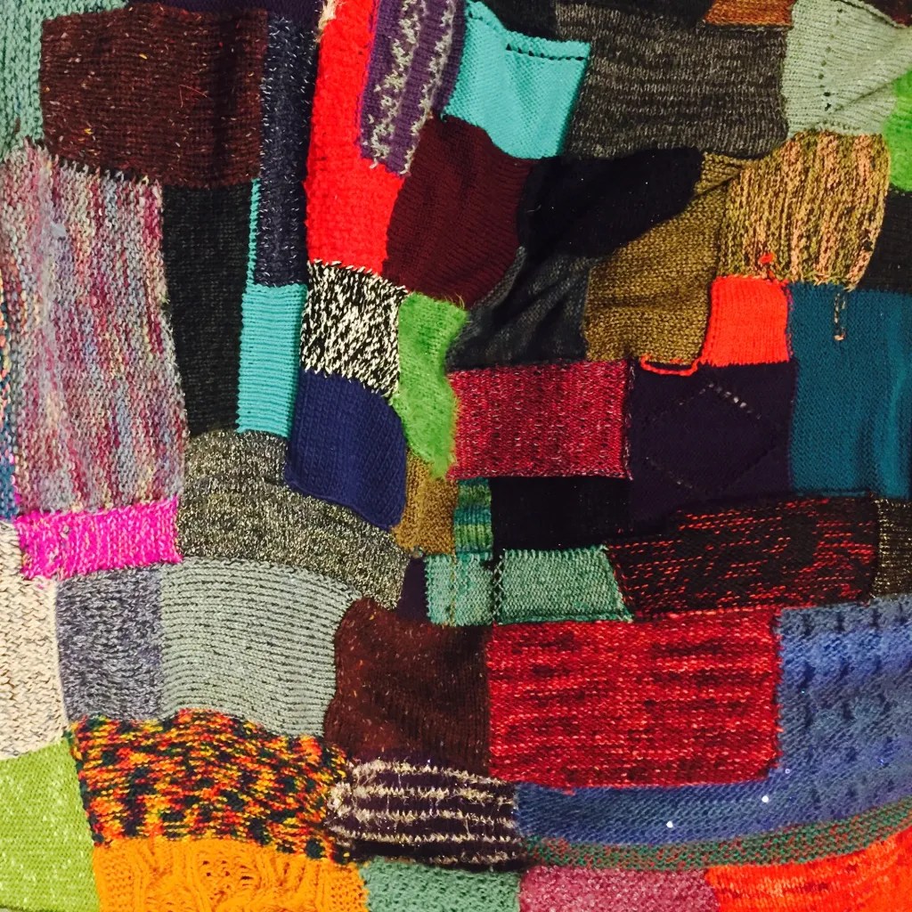 wildly colorful knitting swatches sewn and knit together to create a patchwork fabric