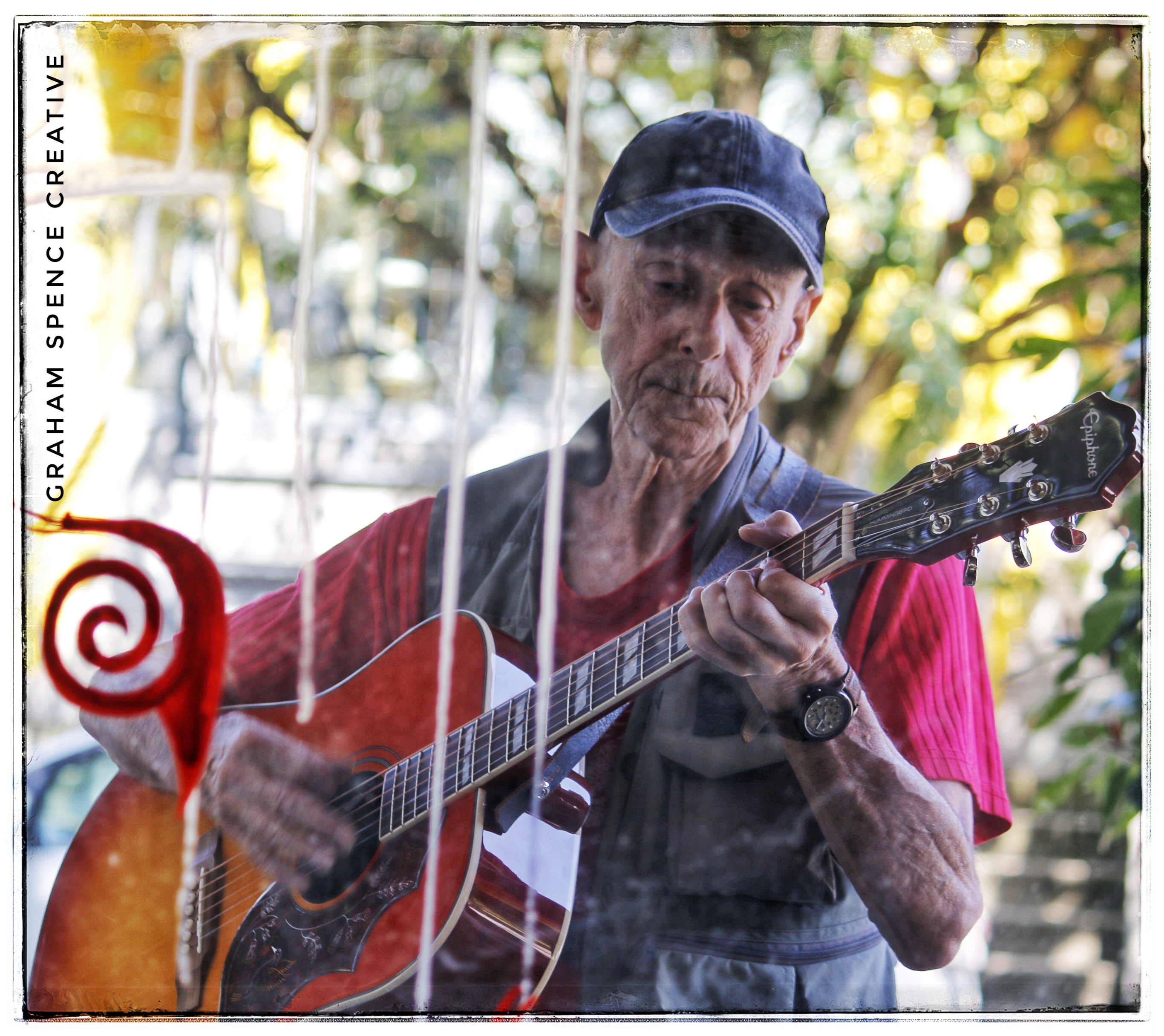 Guitarist entertains the coffee drinkers at Wilder Snail cafe in Strathcona, Vancouver.