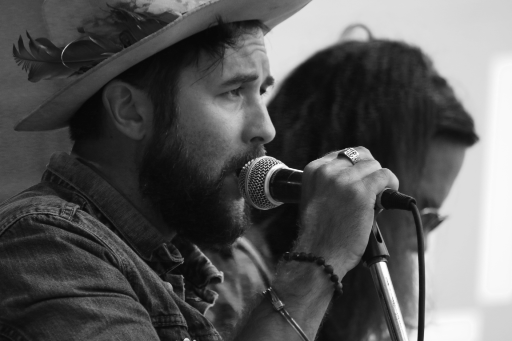 Black and white close-up photo showing a Side profile of The Matinee lead singer Matt Layzell performing on stage at the Recovery Day Festival in New Westminster, BC.