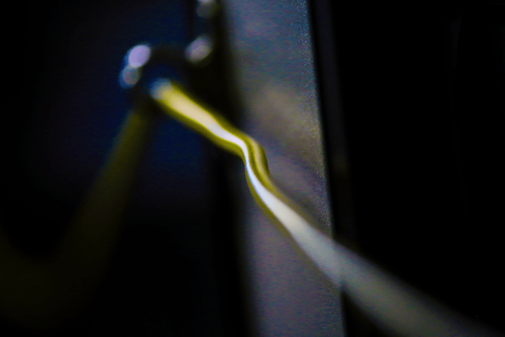 A close-up image showing the famous yellow pull cable that alerts Vancouver bus drivers that someone wants the next stop.