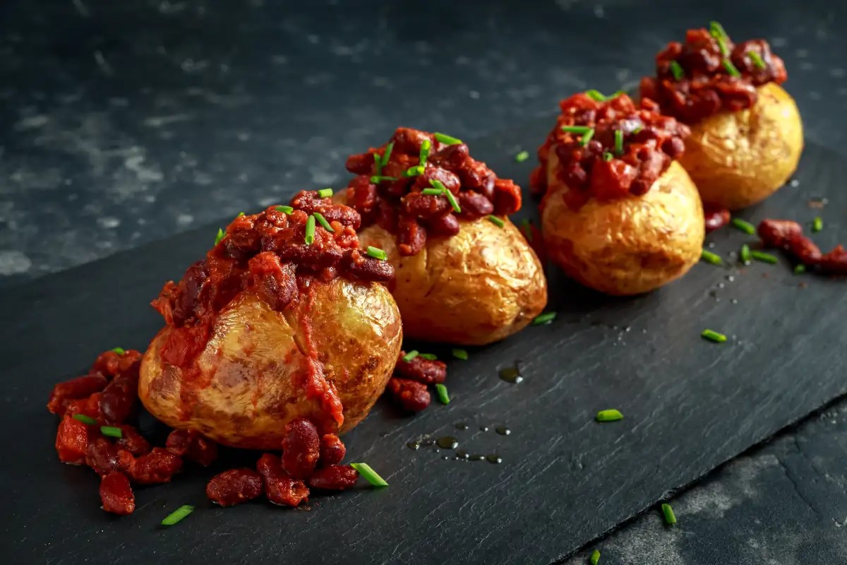 row of jacket potatoes with bacon beans topping