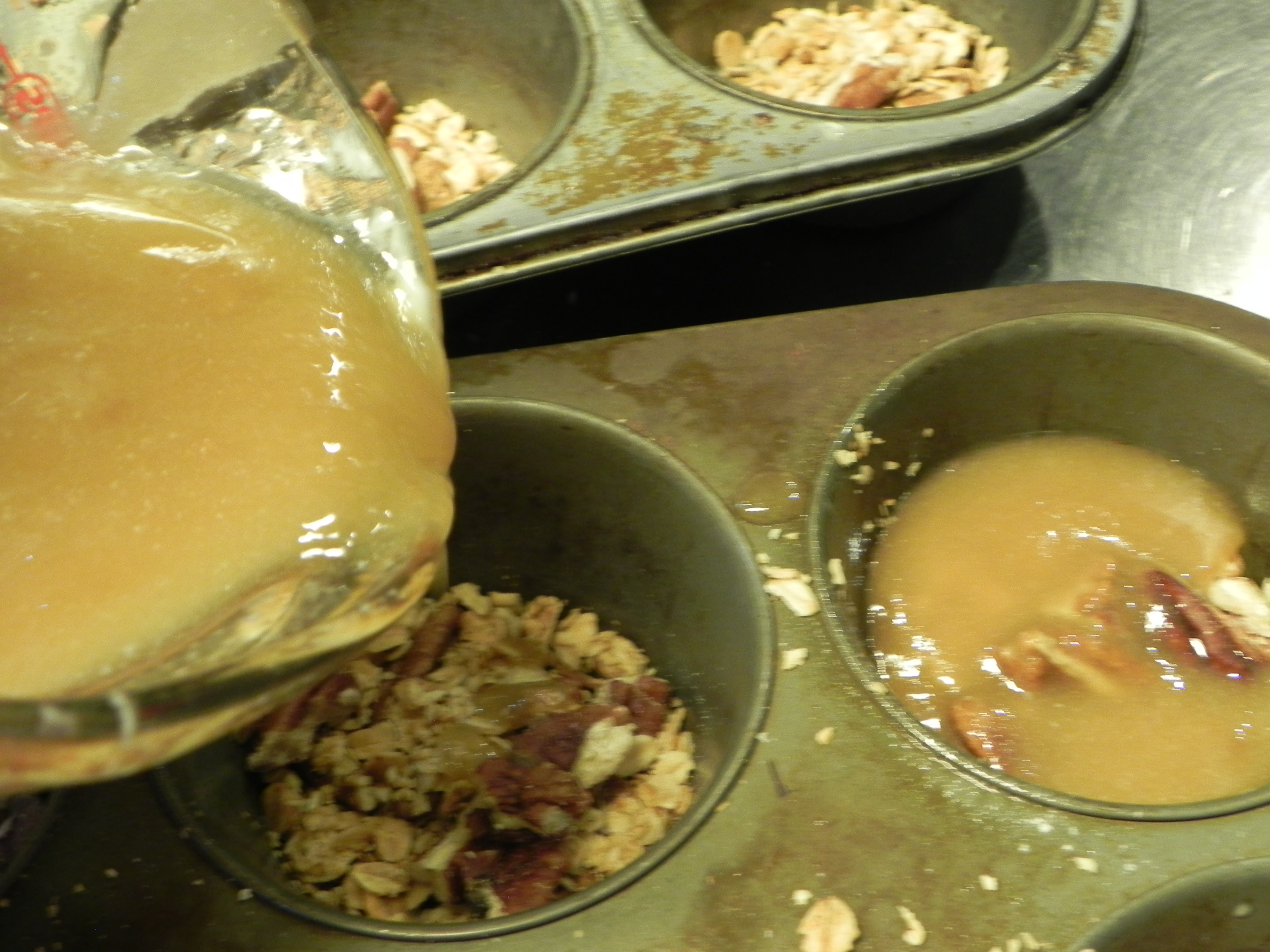 Pouring the topping into the muffin pan.