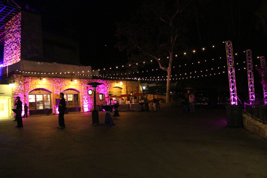 String lights over a courtyard reception