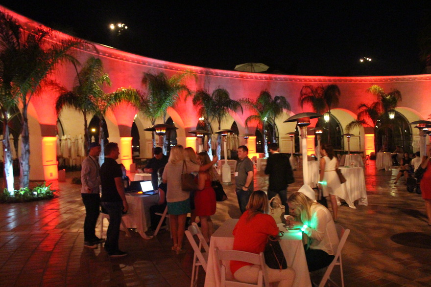 Guests at courtyard reception in red light