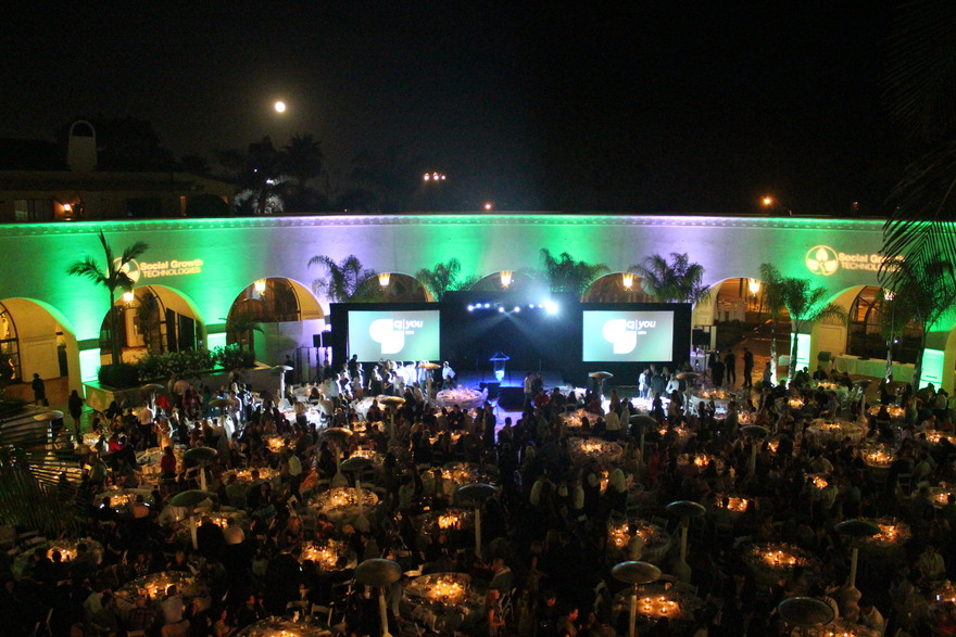 Outdoor gala with screens and green lighting