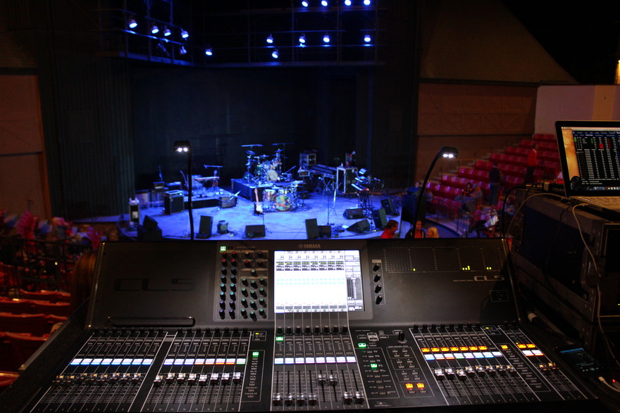 Mixing console facing an empty theatre stage
