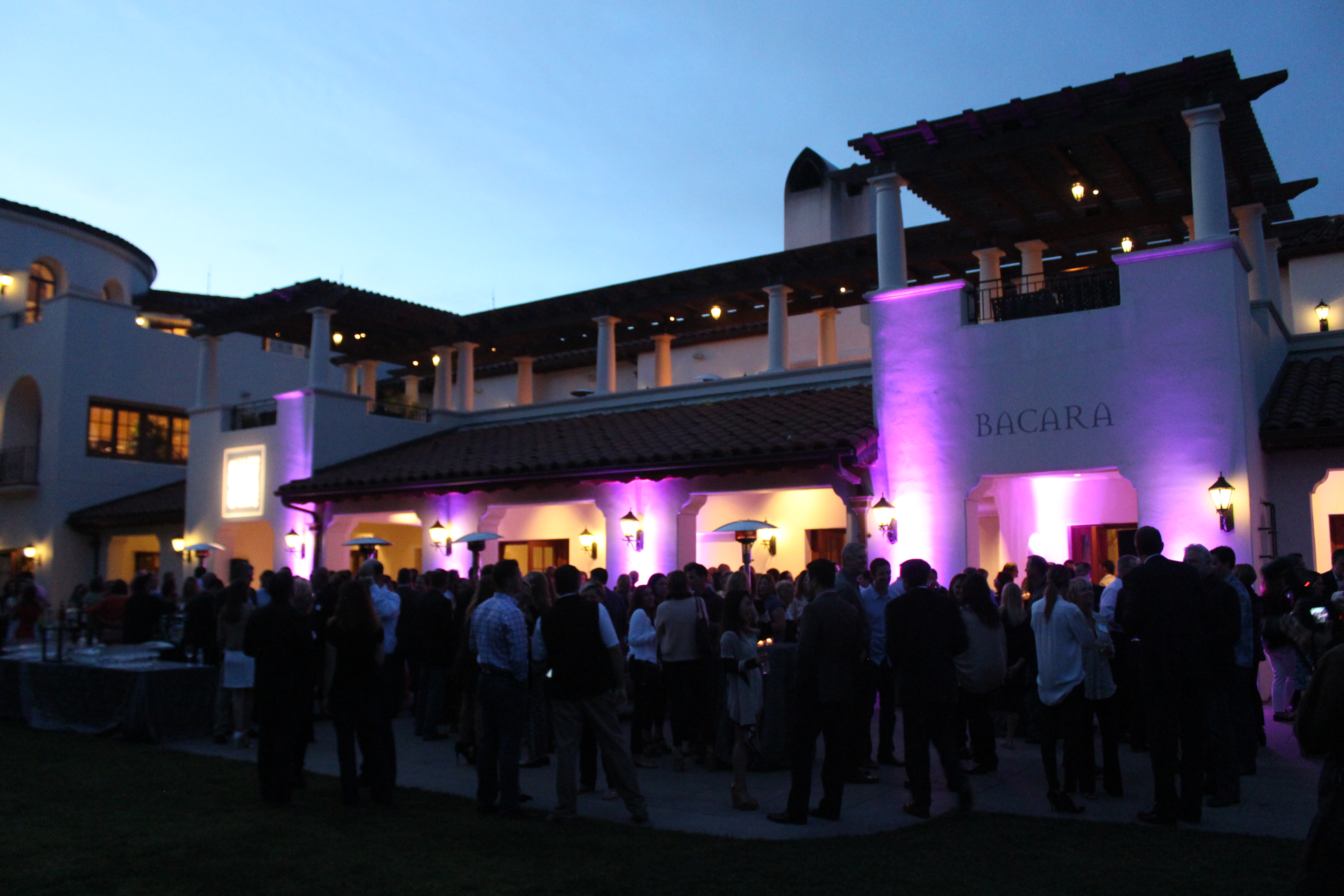 Guests outside a resort at dusk