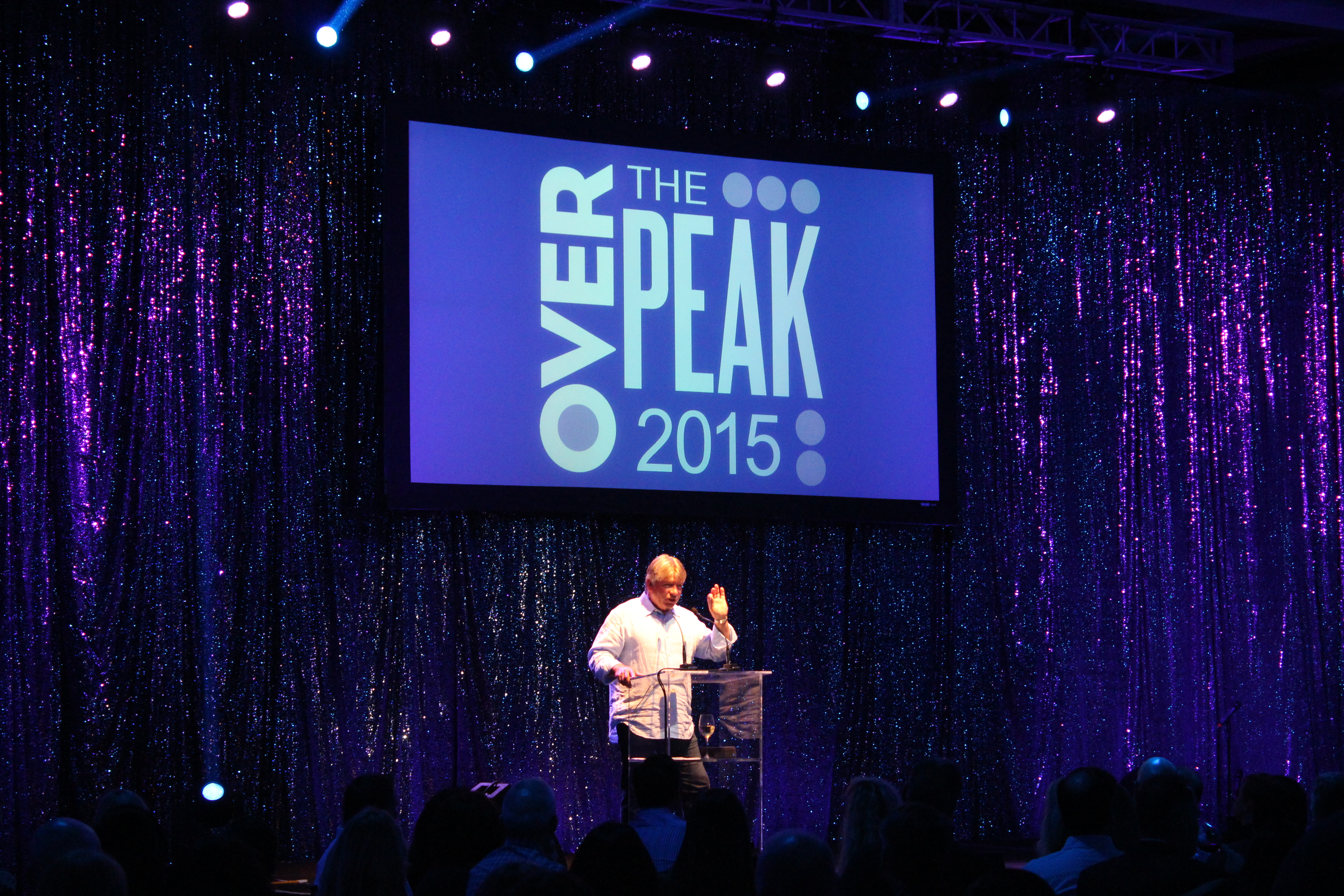 Over The Peak 2015 screen behind speaker
