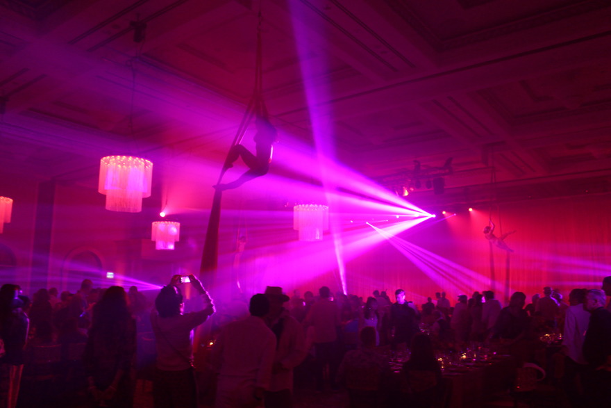 Aerial performer with purple stage lighting
