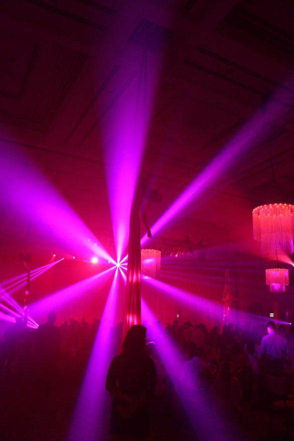 Pink beam fixtures fanned across dark room