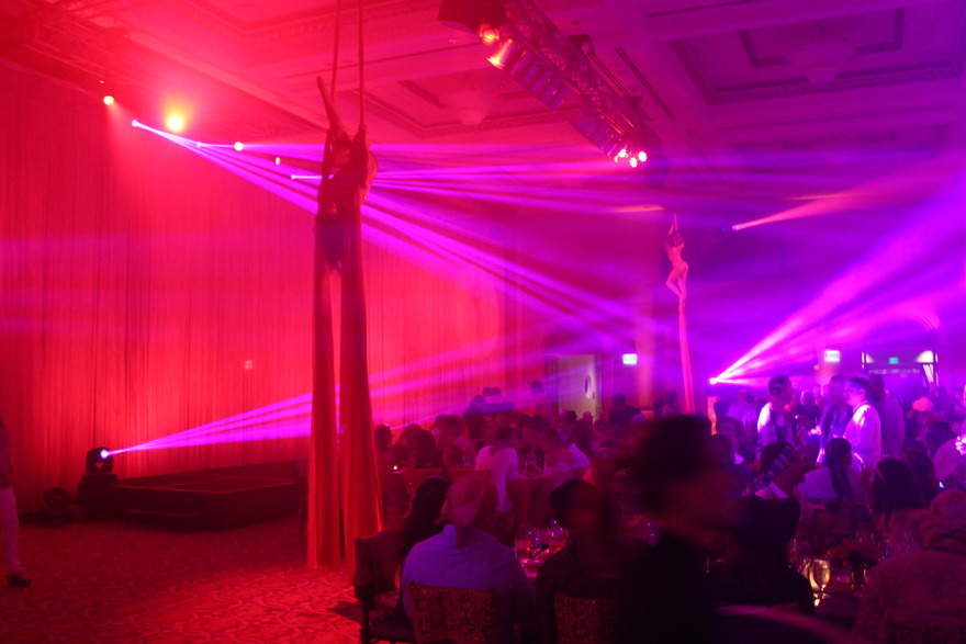 Red beam lighting over a crowded party