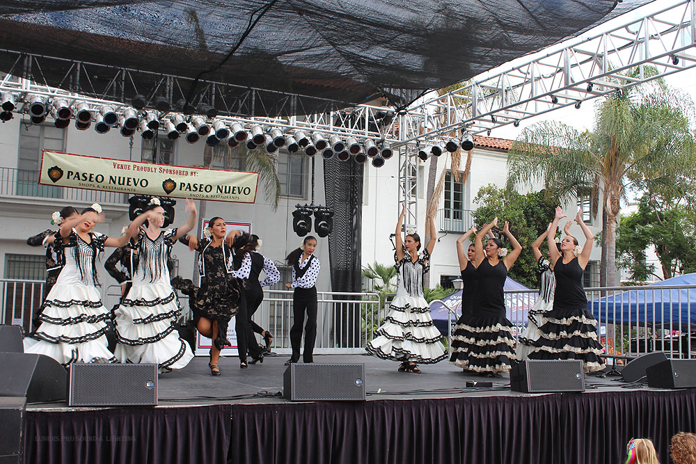 Dancers in white ruffled skirts on stage