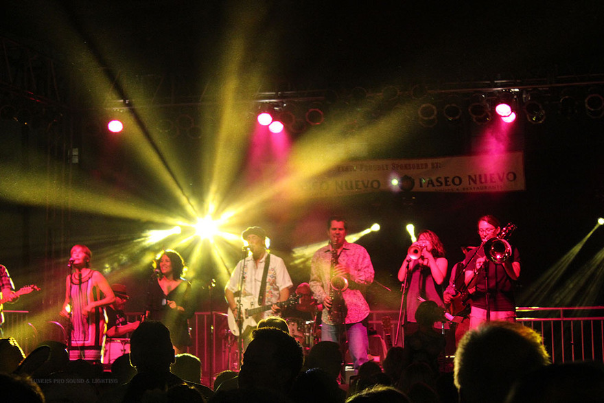 Band lit in gold on festival stage