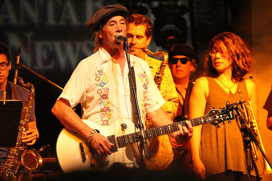 Guitarist and horn player on festival stage