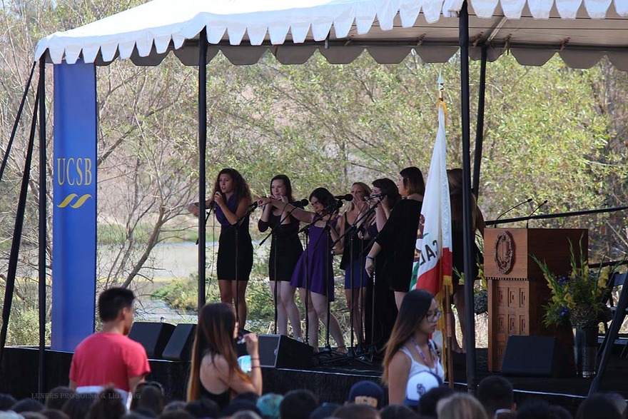 Student singers performing under a campus canopy