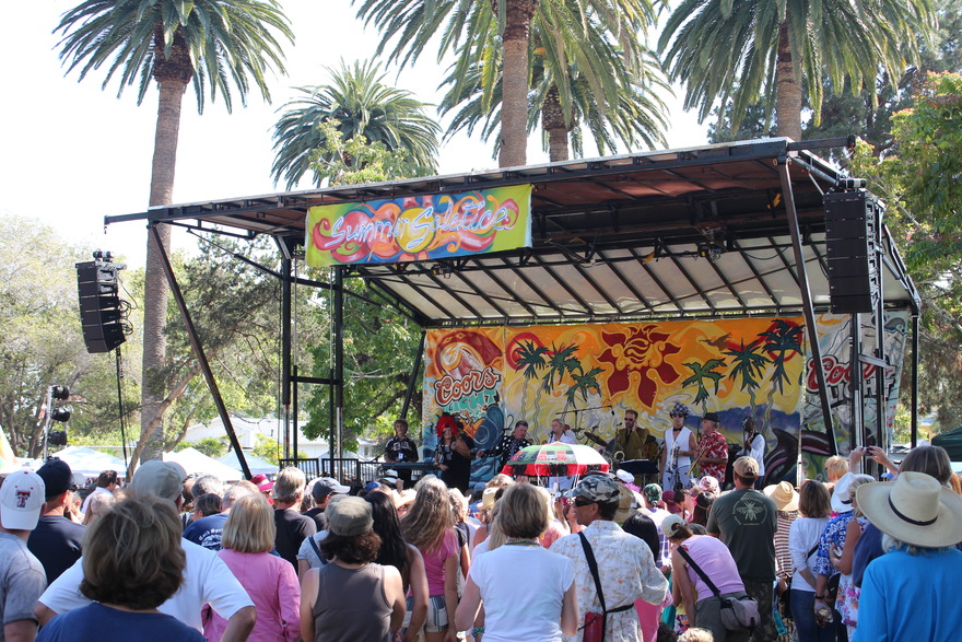 Painted festival stage above a daytime crowd