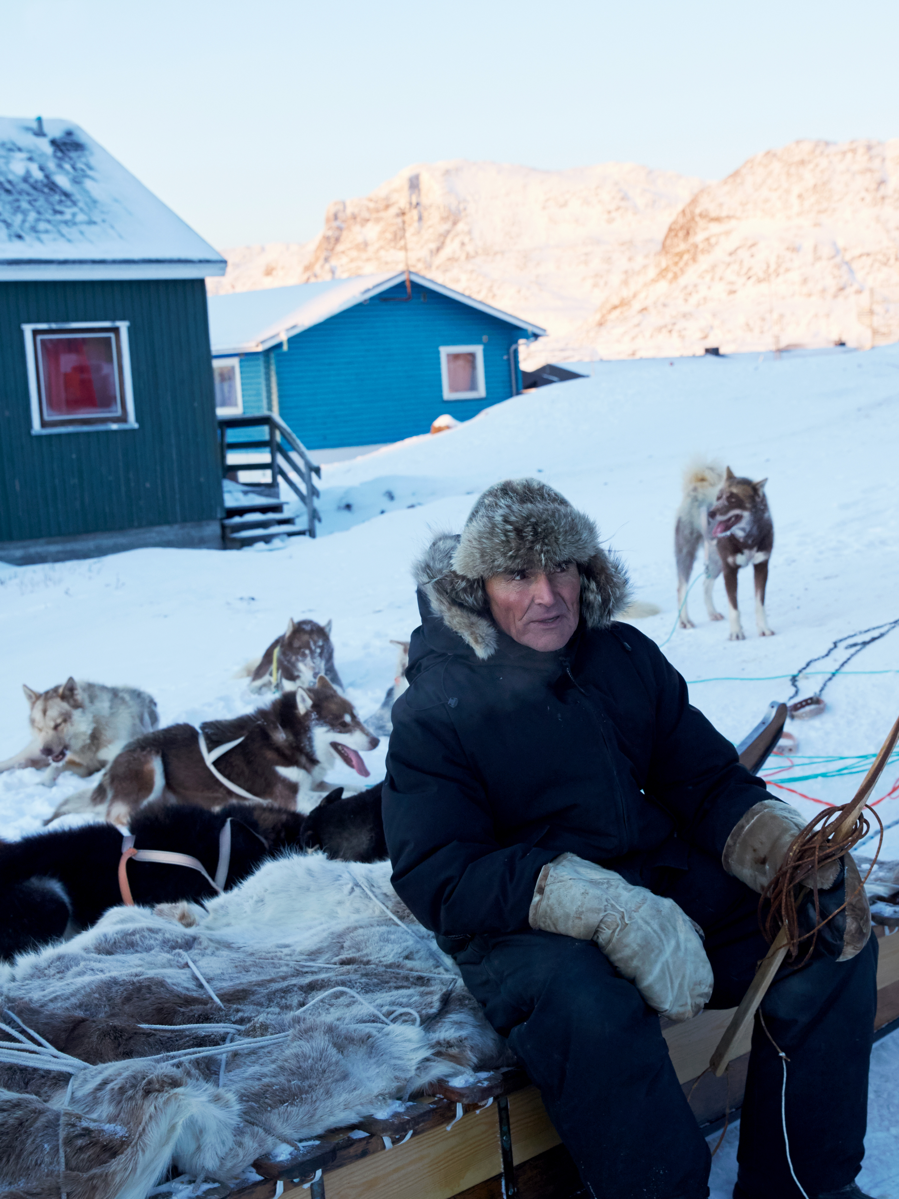 Dog sled master in Greenland by Axel Sig