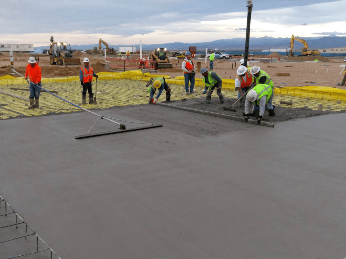 GR Concrete Construction crew placing and finishing structural concrete slab for Hach R&D facility expansion in Loveland