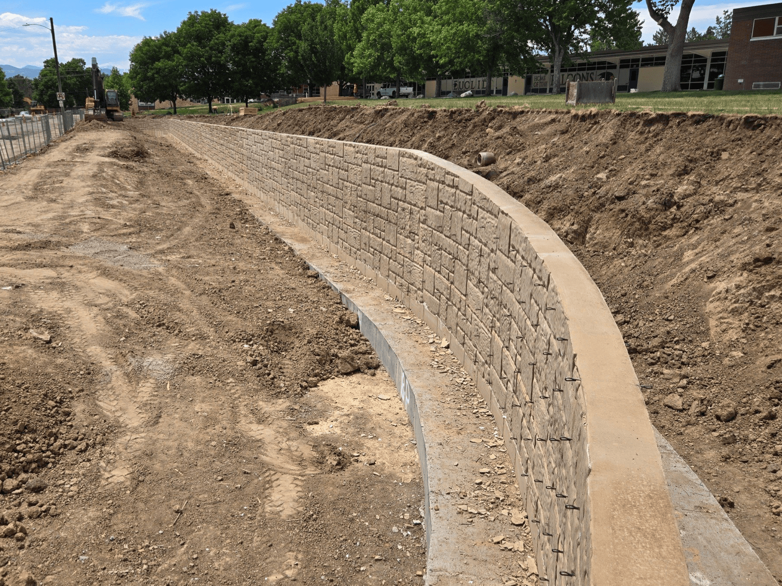 Finished architectural concrete retaining wall with decorative form liner at school site in Littleton Colorado