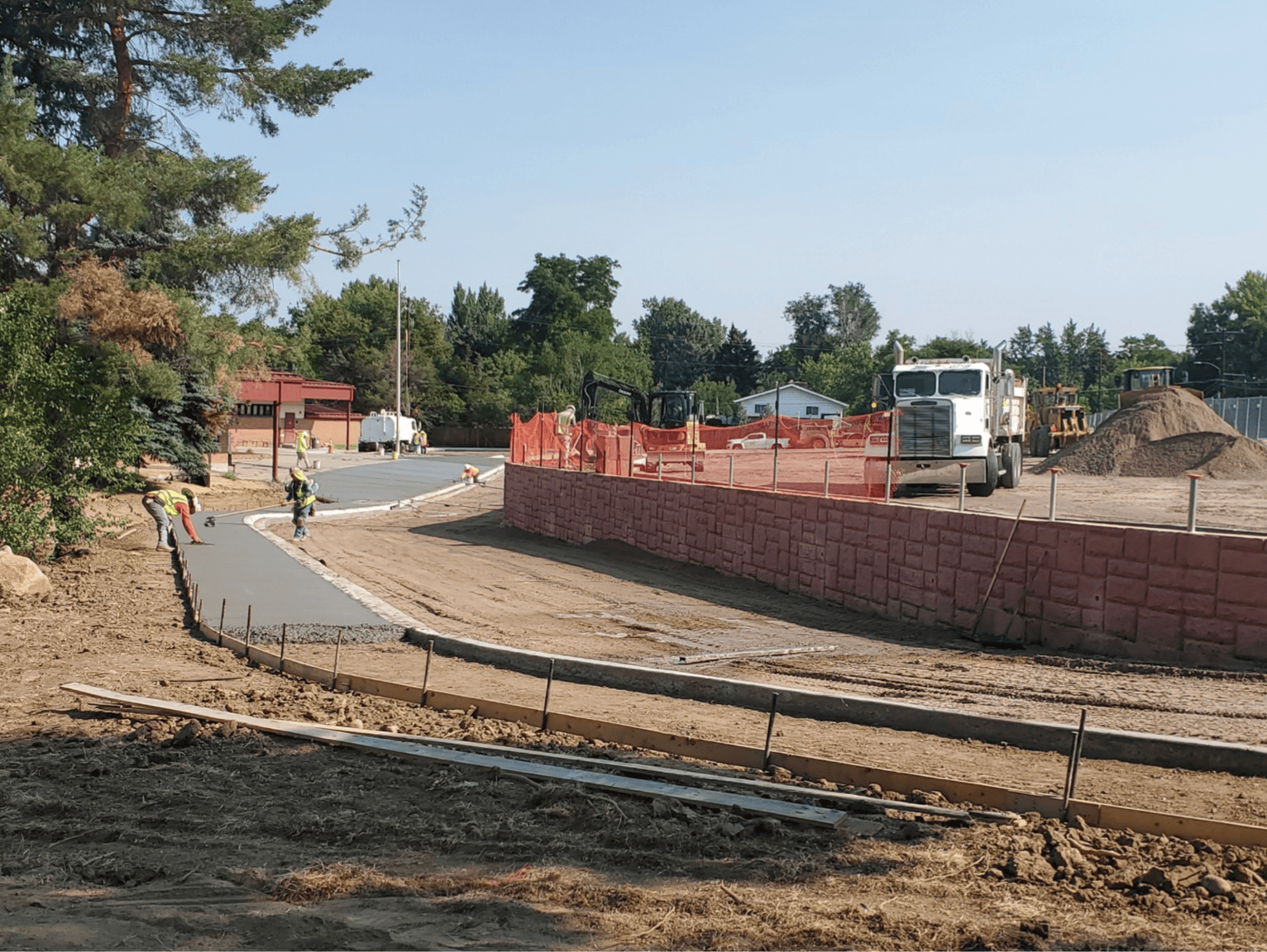 Concrete flatwork placement for ADA sidewalk and curb at school site construction project in Littleton Colorado