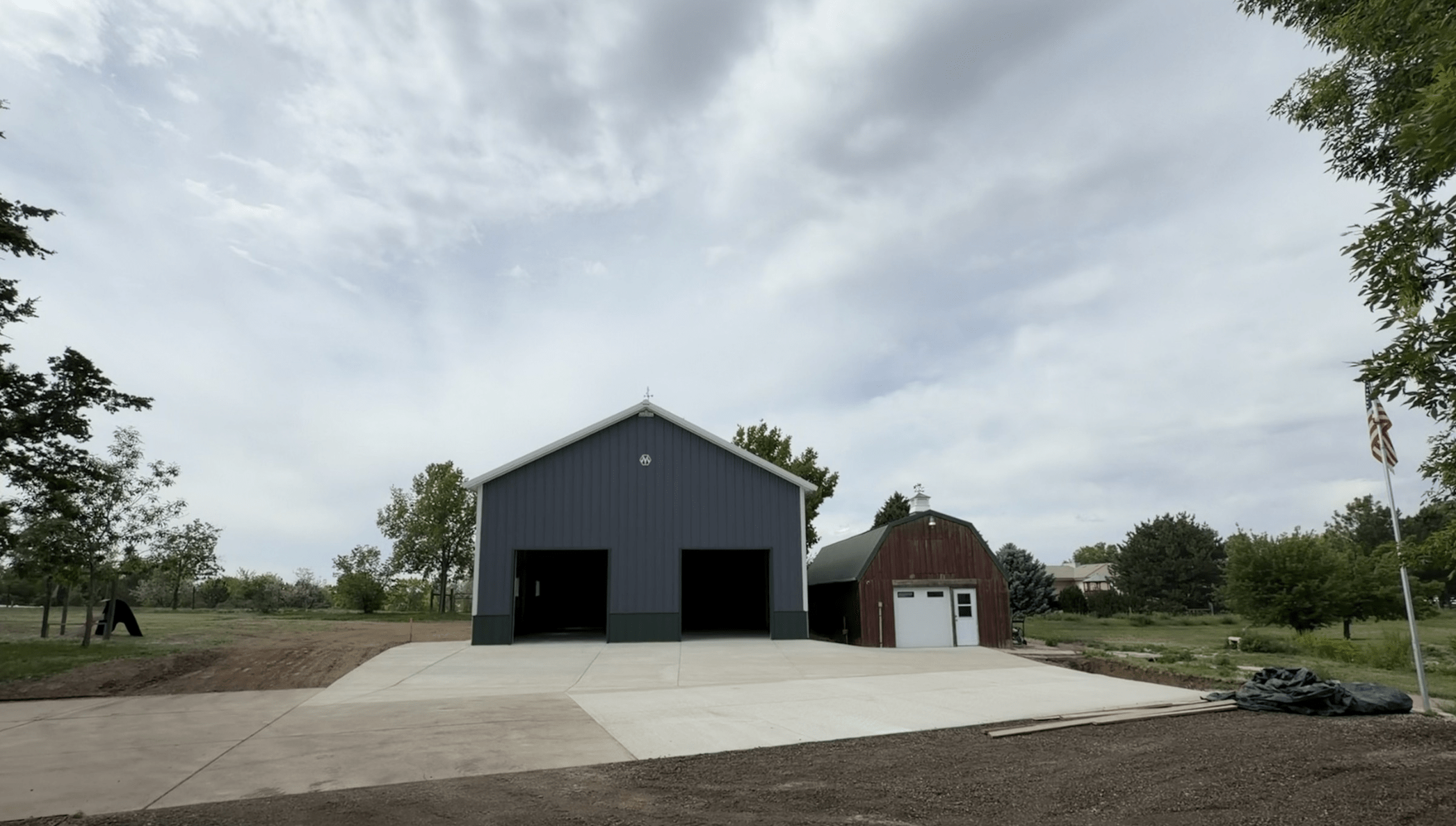 Completed detached garage concrete floor slab and exterior apron enhancing functionality and access on a residential property.