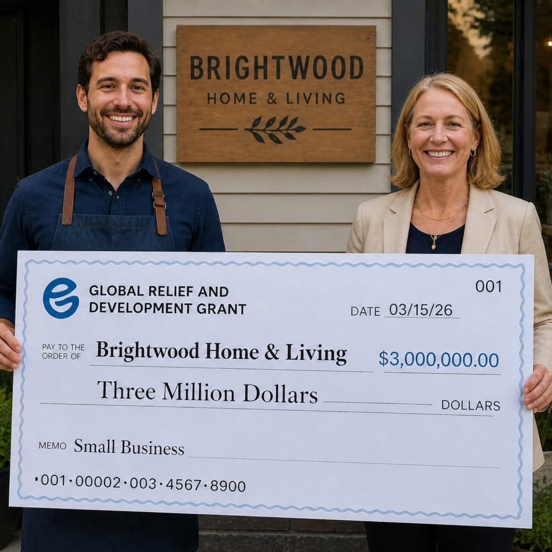 People holding a Global Relief & Development Grant award check at Brightwood Home & Living