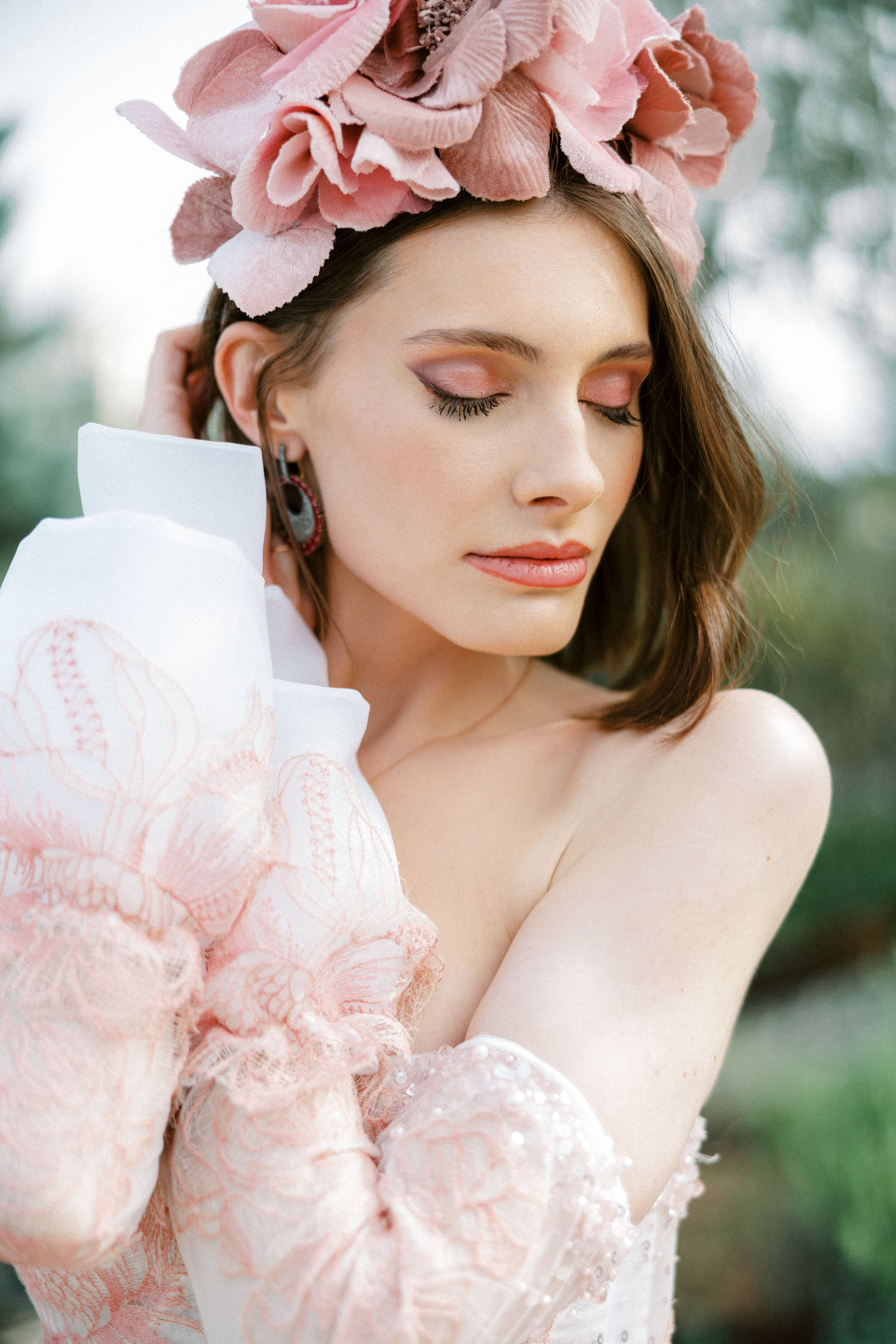 bride with pink floral hairpiece and pink eye shadow