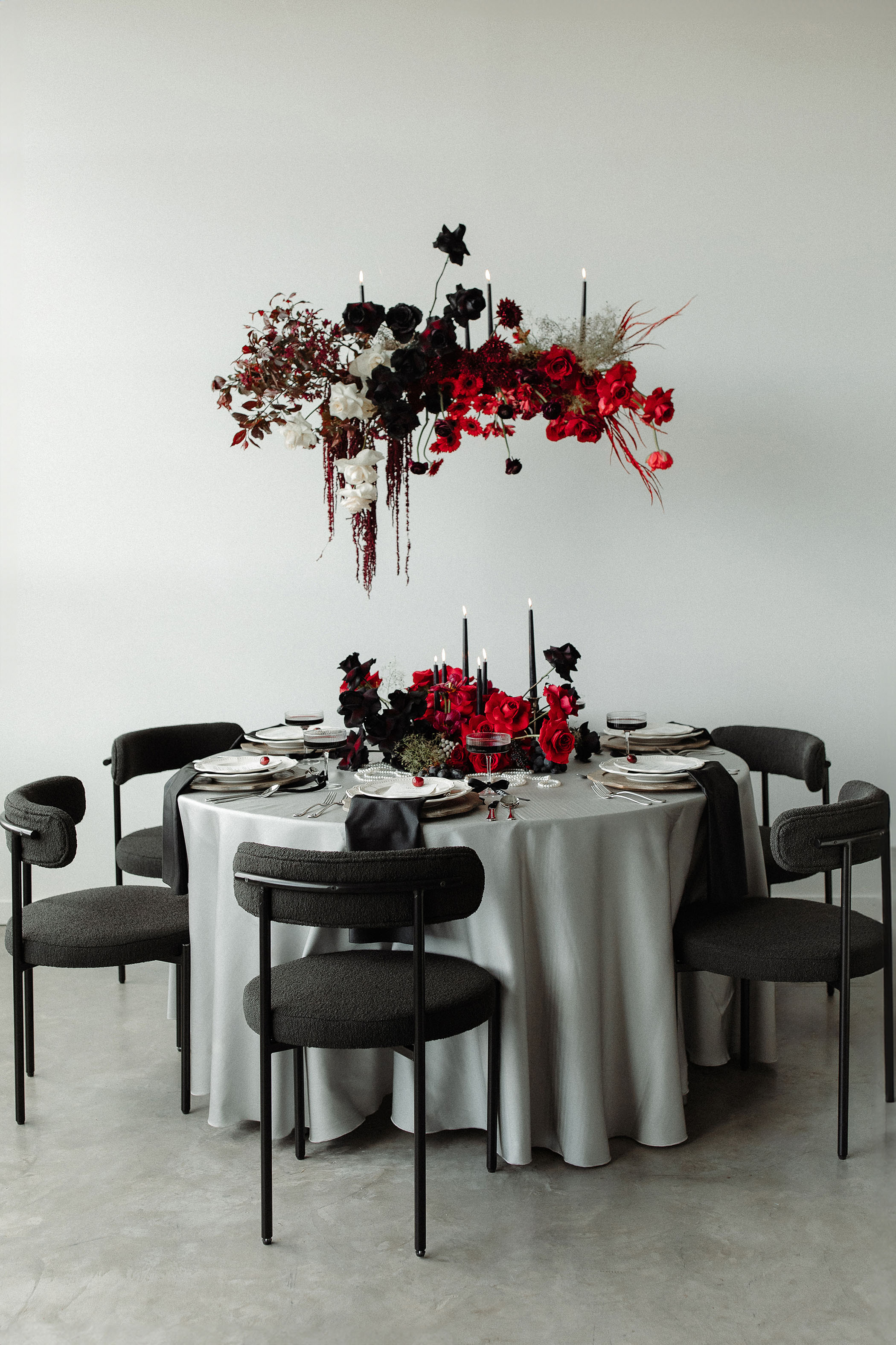 a tablescape with moody black and red hanging florals for a Taylor Swift TTPD inspired wedding photoshoot