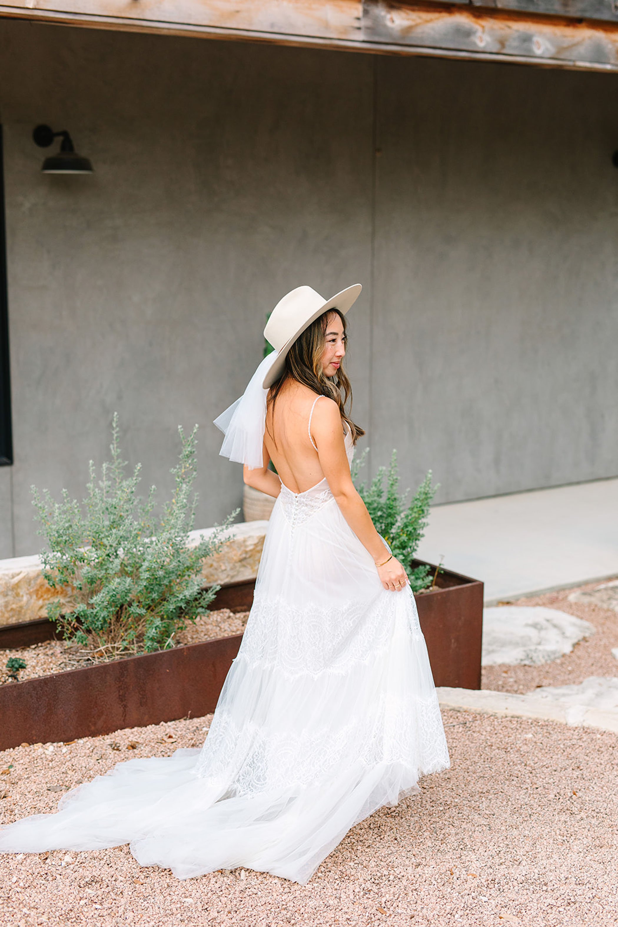 bride wearing a cowboy hat with wedding dress