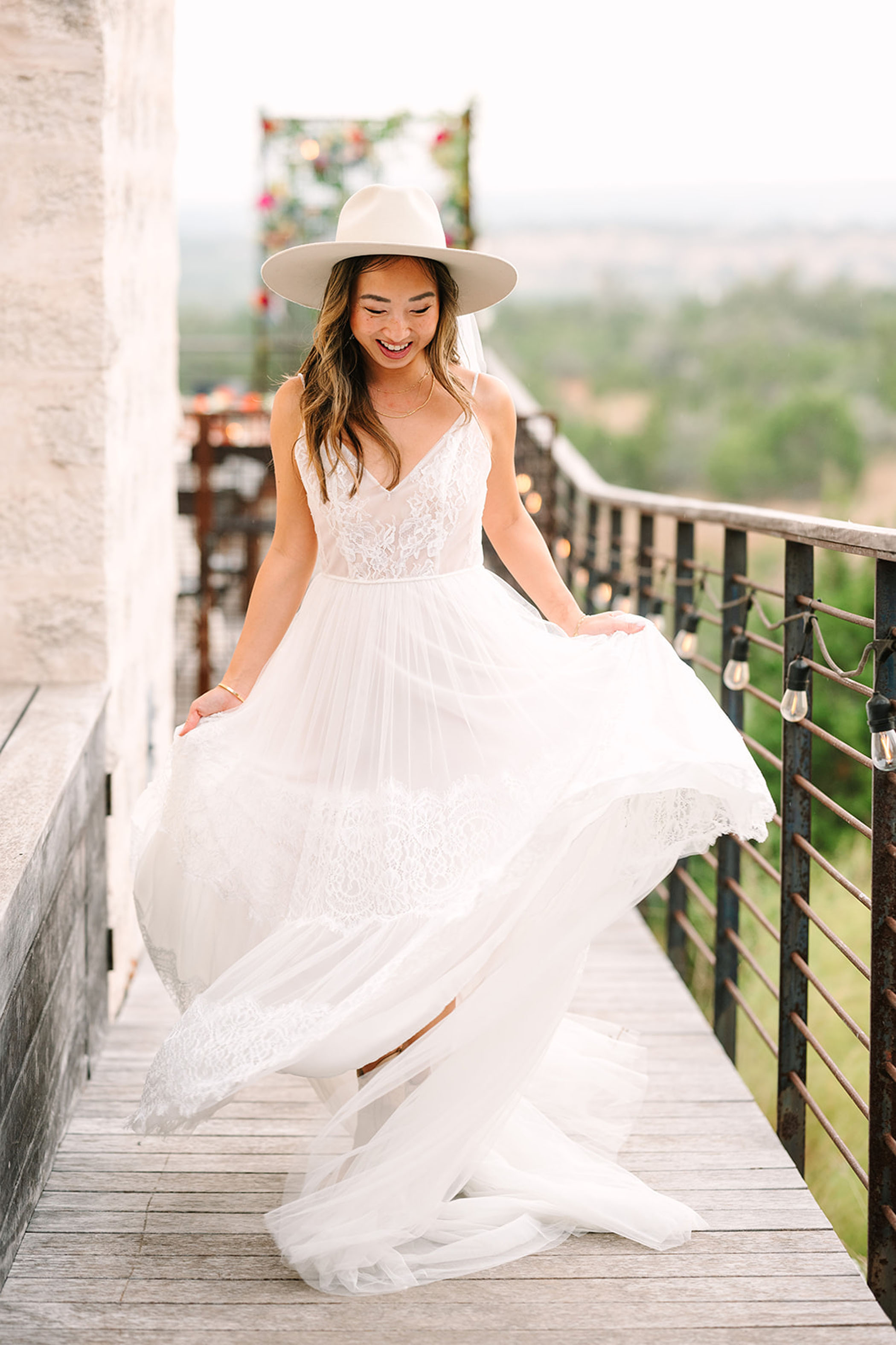 bride wearing a cowboy hat with her wedding dress