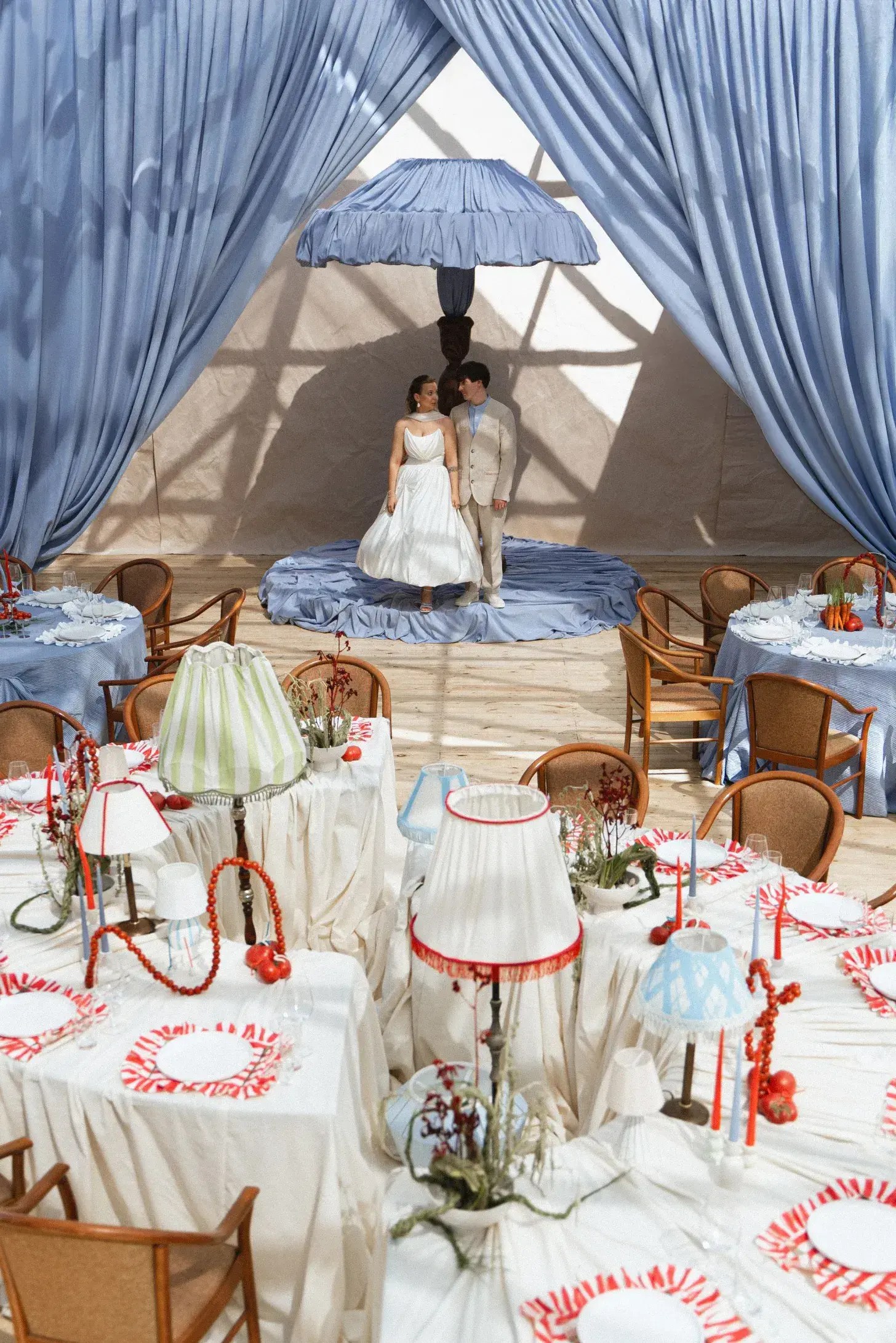 bride and groom for their blue wedding with red details