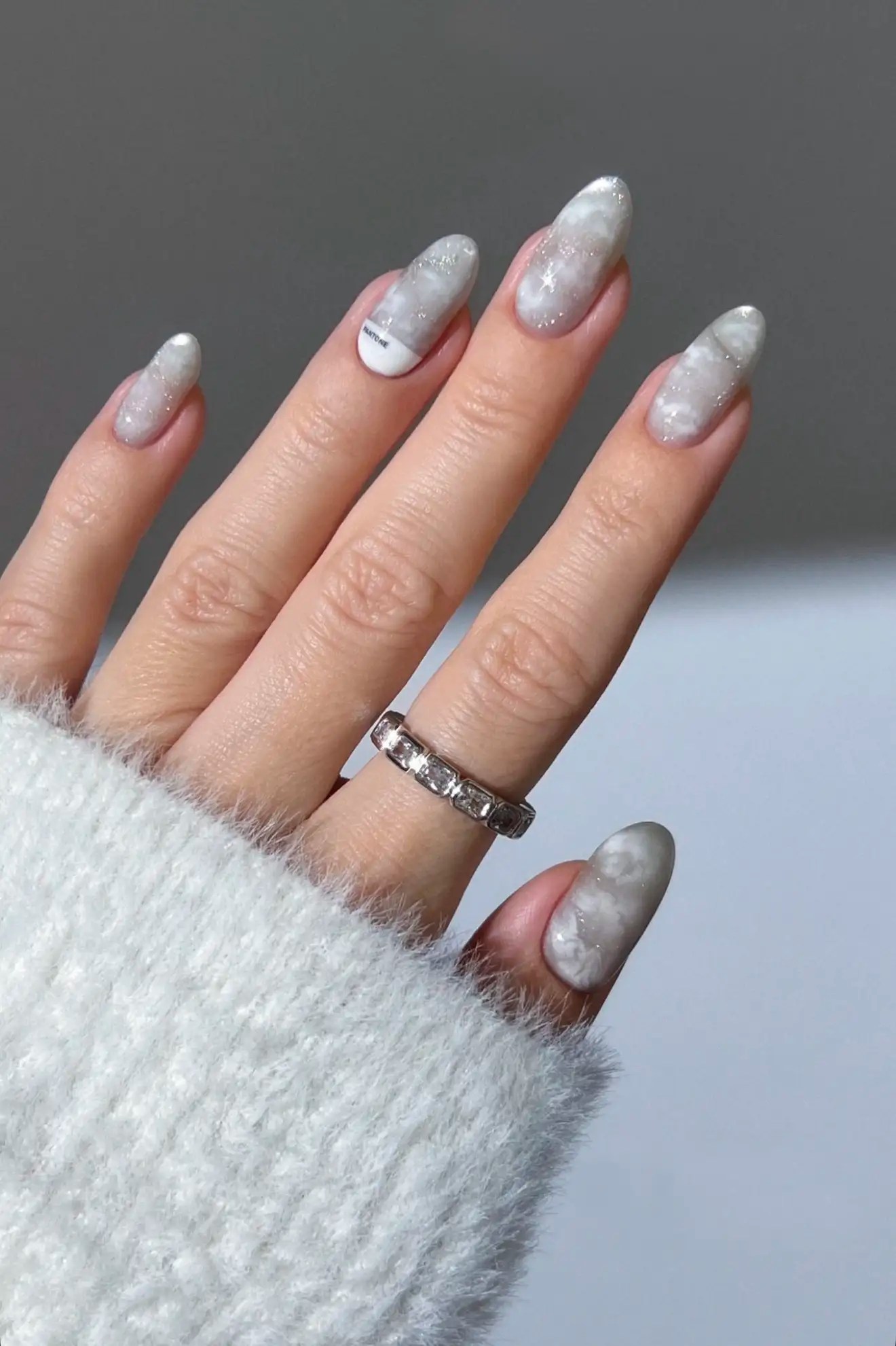 almond shaped white nails with cloudy designs inspired by the Pantone 2026 Color of the Year "Cloud Dancer"