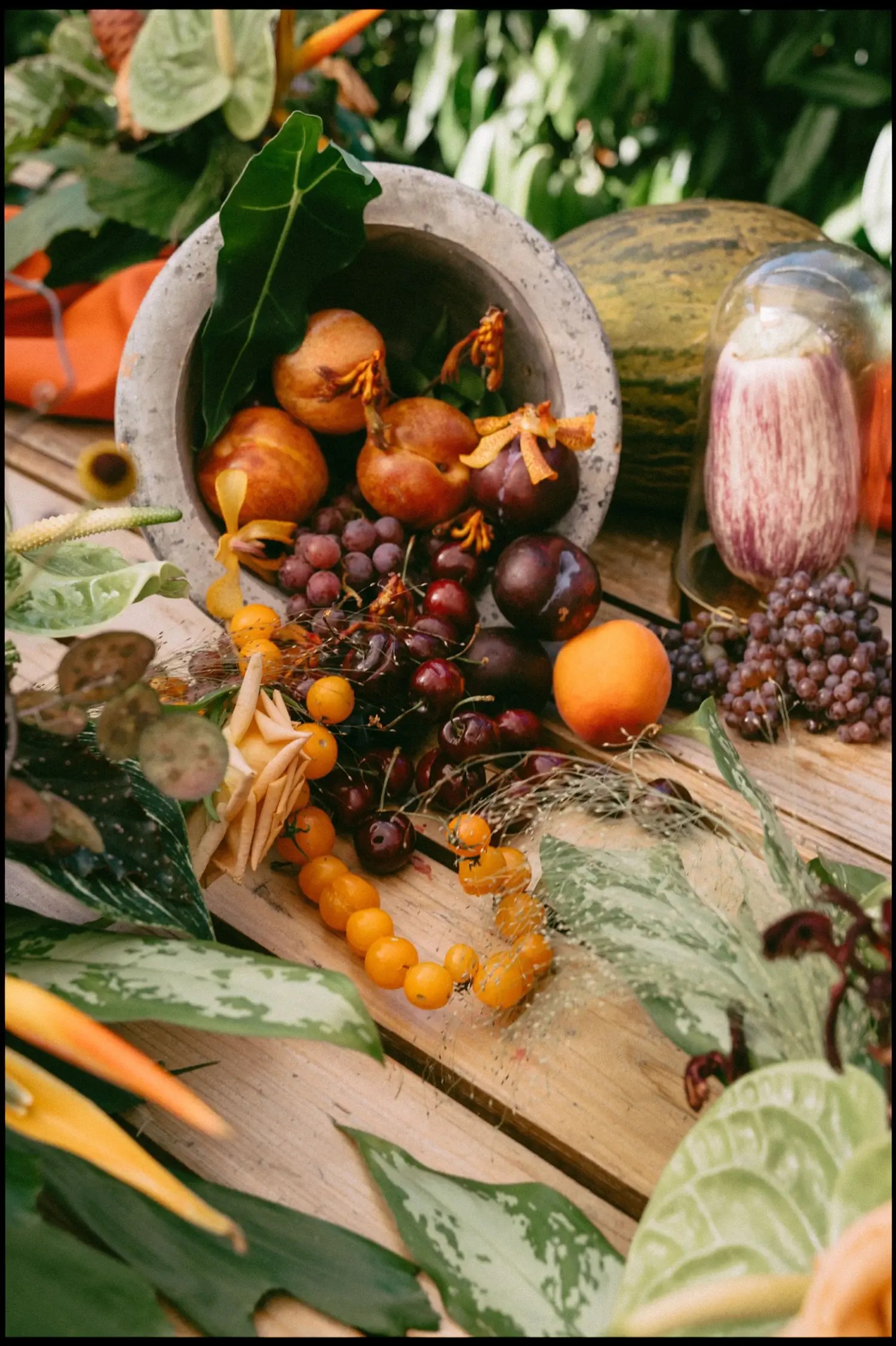 tomatoes and fruit in a vessel on table