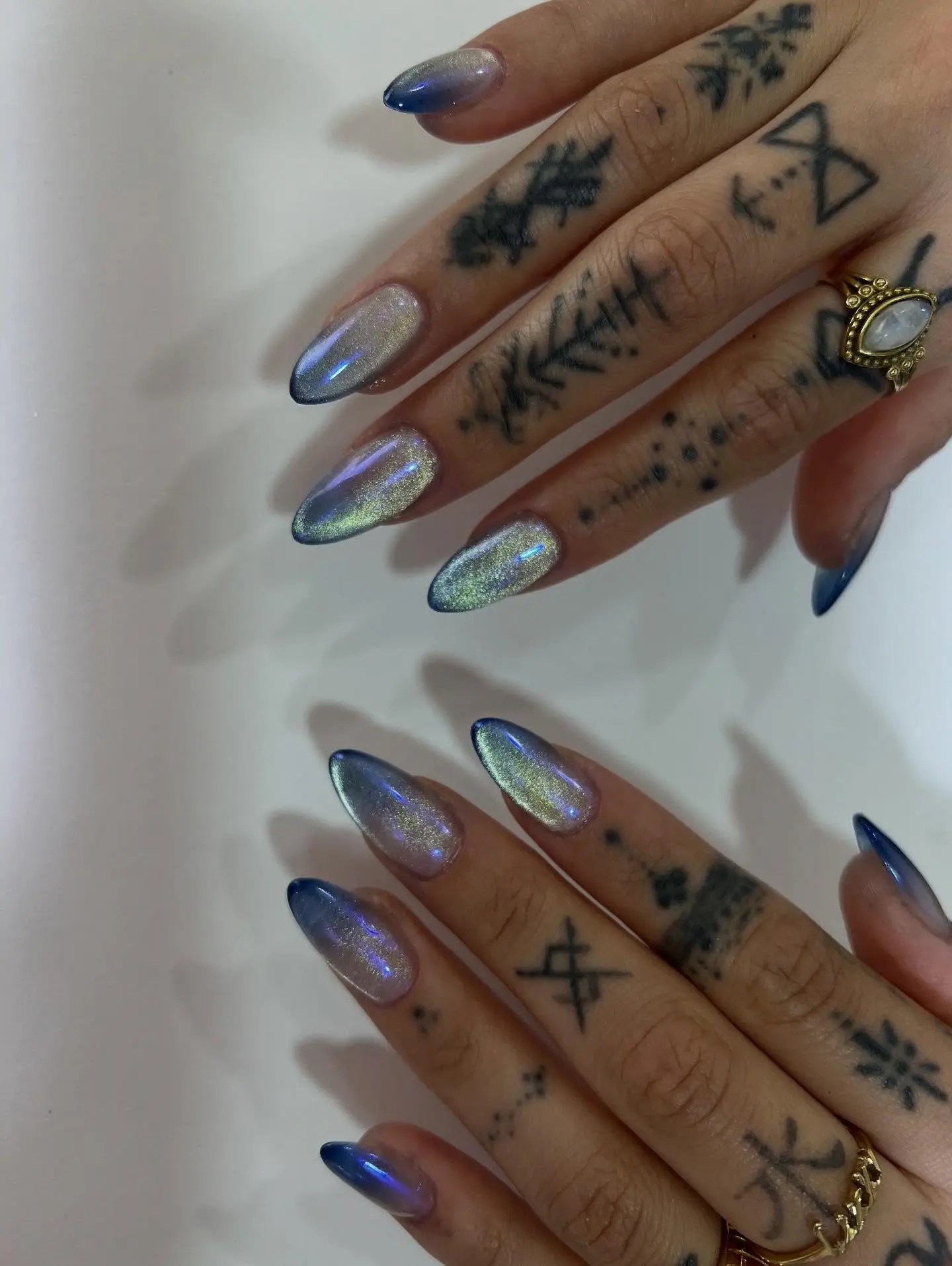 ombre blue cat eye nails with a shimmery chrome finish