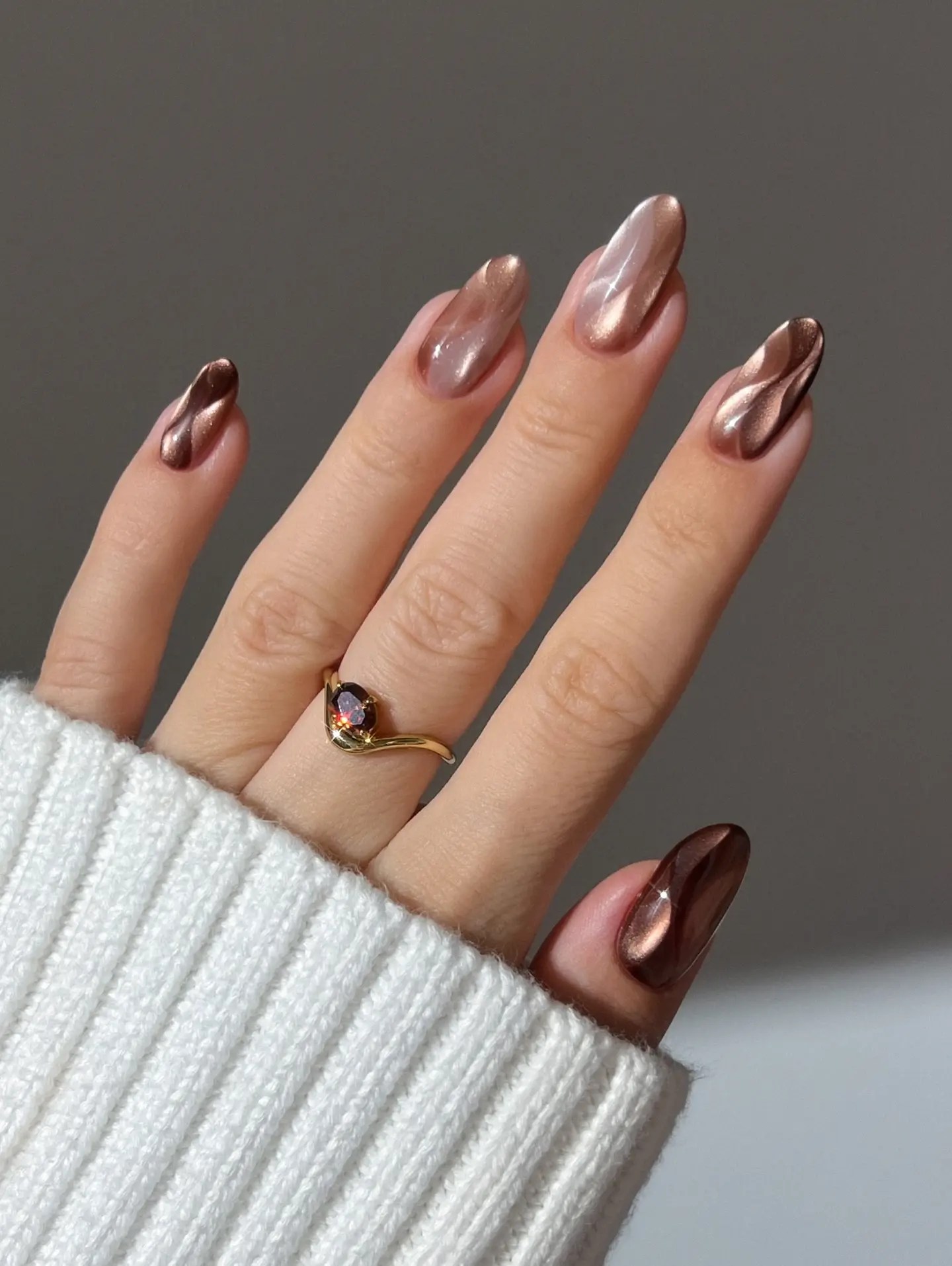 Fall classy nails in bronze and rose gold chrome with a sculpted swirl running through each nail