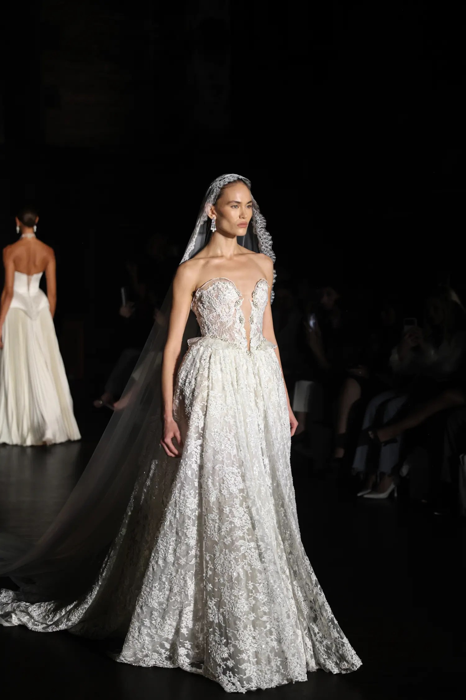 Alon Livné Fall 2027 lace A-line gown with sheer veil and crystal headpiece