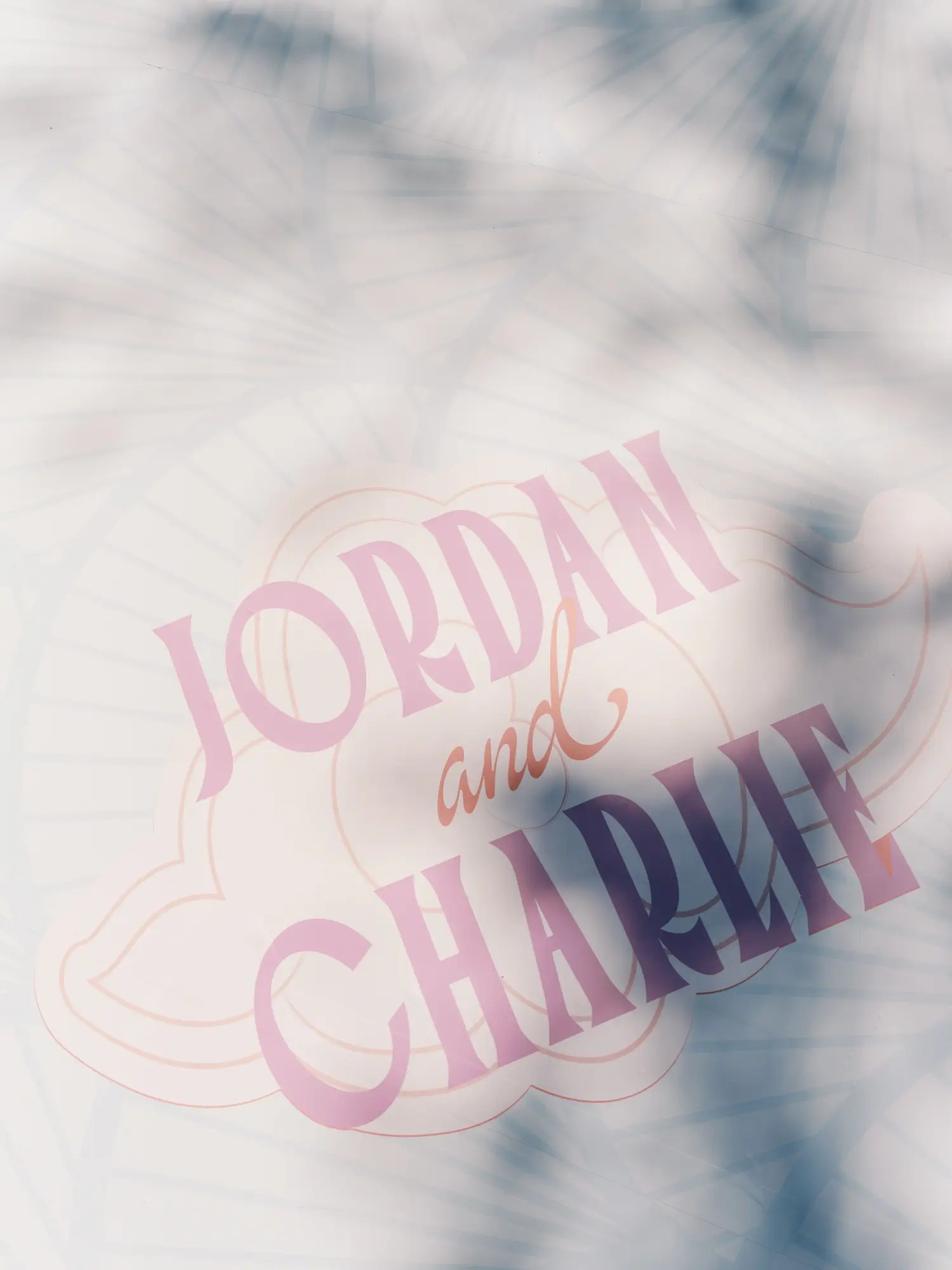 Jordan and Charlie pink monogram printed on a white wedding dance floor